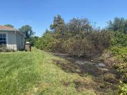 Charred ground near home from brush fire